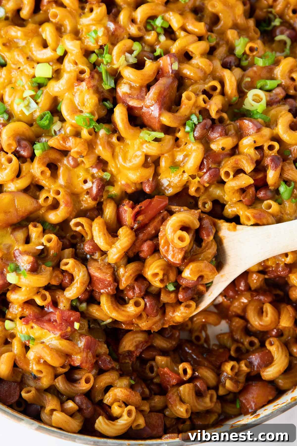 One Pot Wonder Chili Mac 4 A large pan of One-Pot Chili Mac, glistening with melted cheese, with a serving spoon resting inside, ready for family dinner.