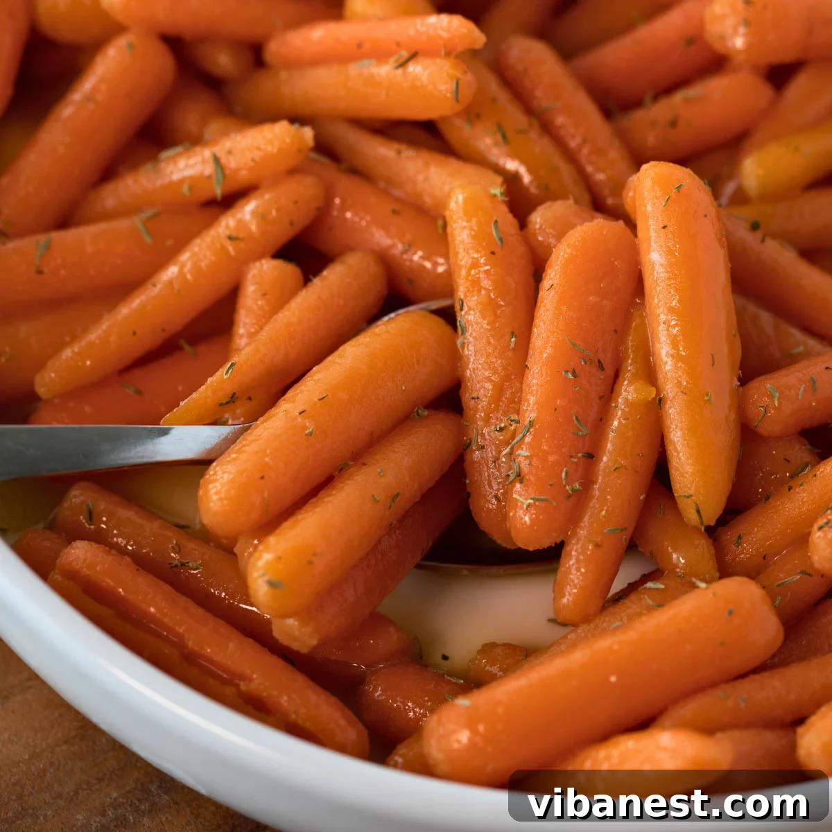 Glistening Brown Sugar Baby Carrots 2 Irresistible brown sugar glazed baby carrots in a serving bowl, ready to enjoy.