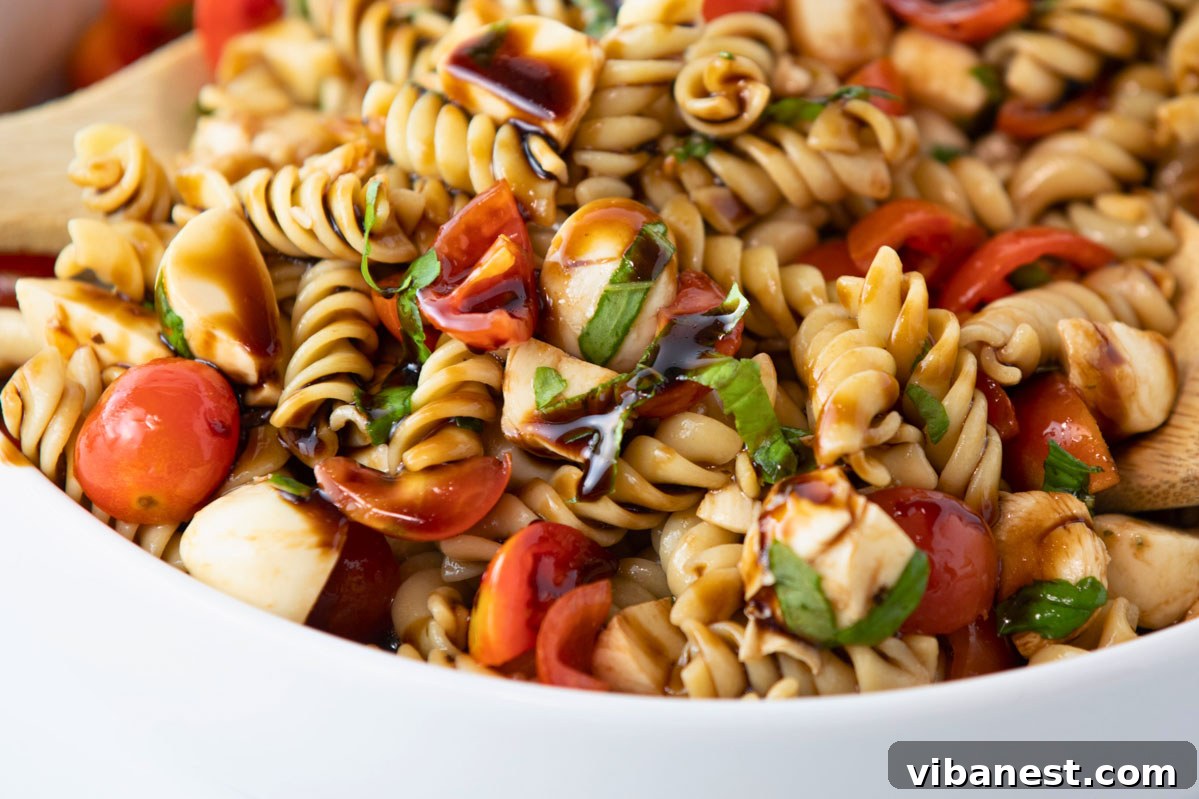 Garden Fresh Caprese Pasta Salad 4 caprese pasta salad with tomatoes, mozzarella cheese, balsamic vinaigrette dressing, close up