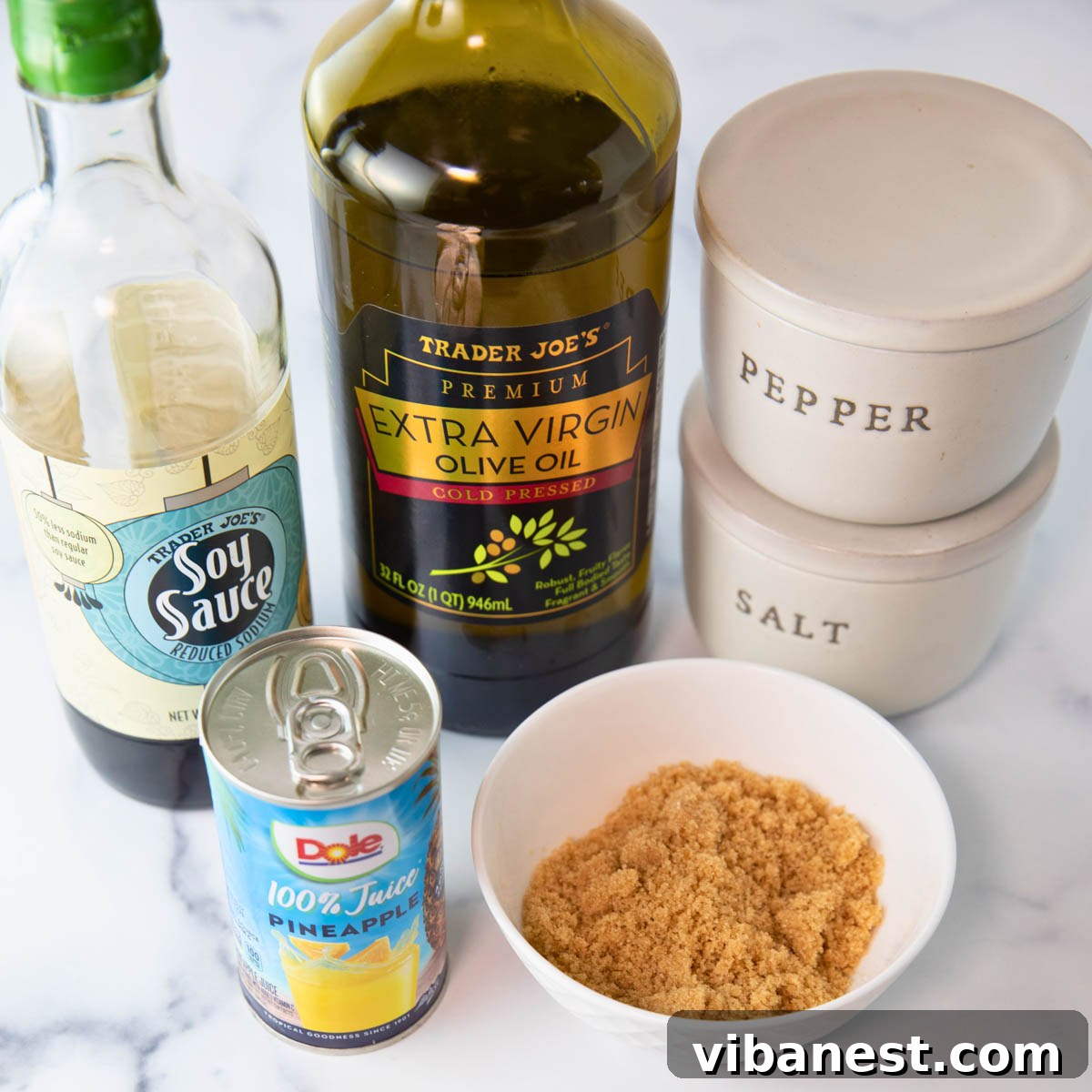 Char-Grilled BBQ Chicken Skewers 3 Marinade ingredients laid out, including soy sauce, pineapple juice, brown sugar, olive oil, salt, and pepper
