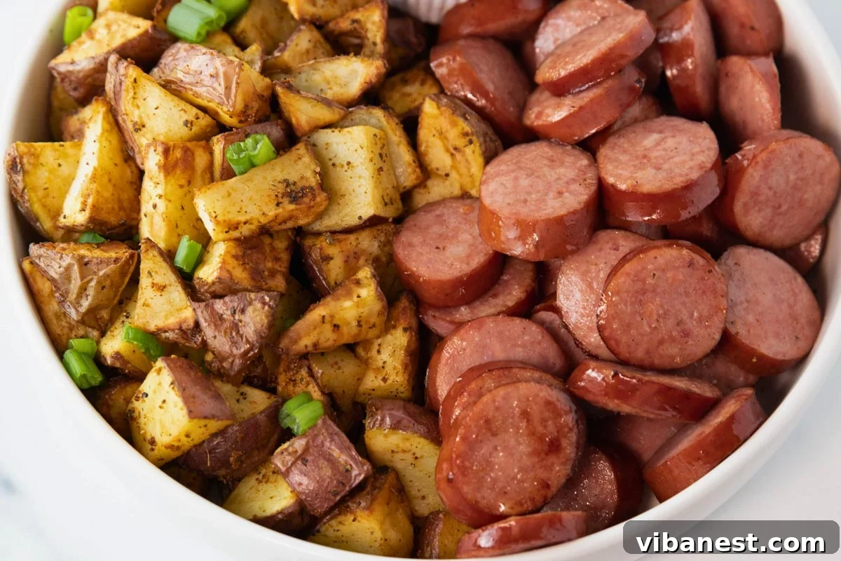 Smoky Air Fryer Sausage and Crispy Potato Medley 5 A serving bowl filled with a generous portion of air fryer kielbasa and potatoes, ready to be enjoyed.