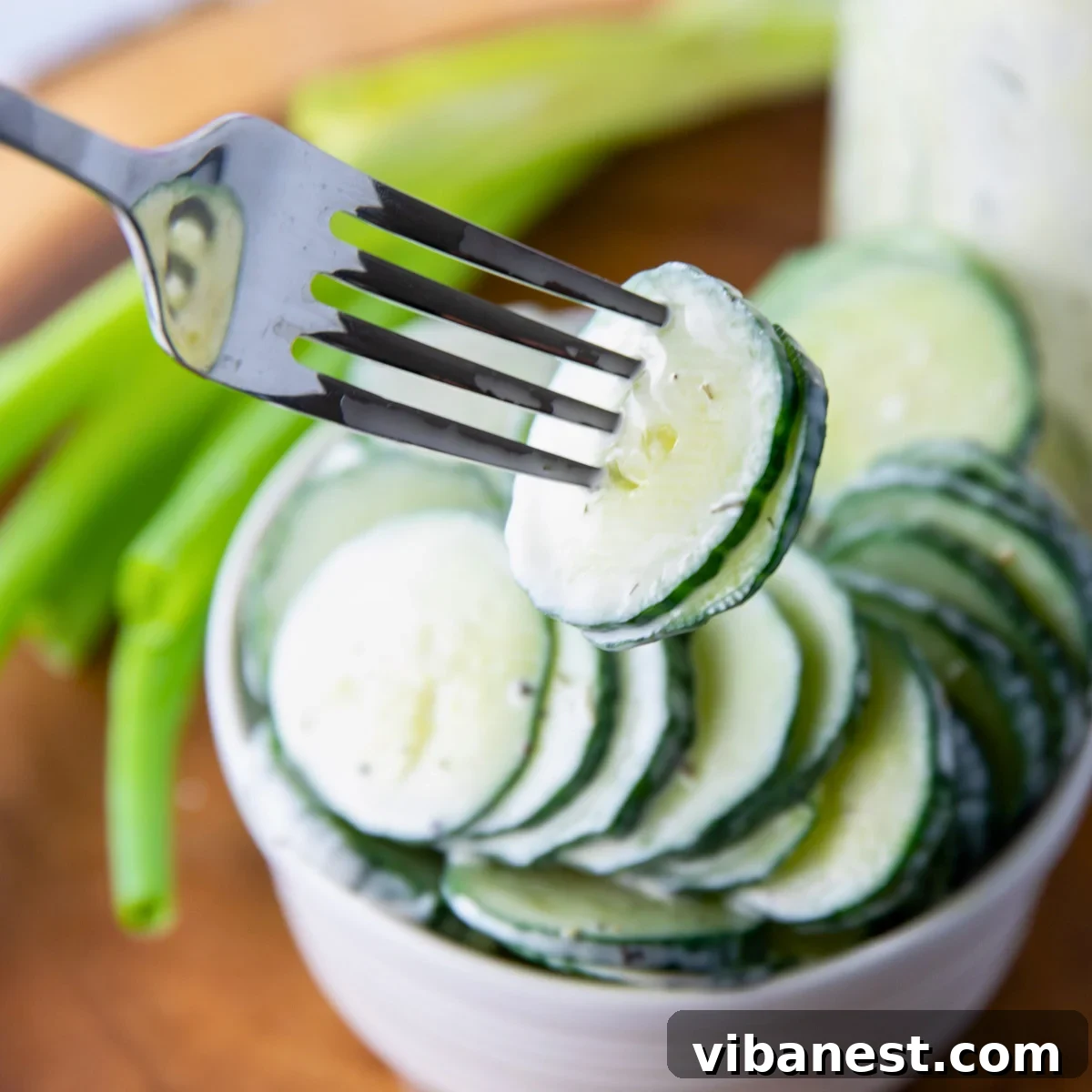 TikToks Viral Cucumber Salad Duet 11 Creamy cucumber salad in a glass jar, garnished with fresh dill, ready to be served.