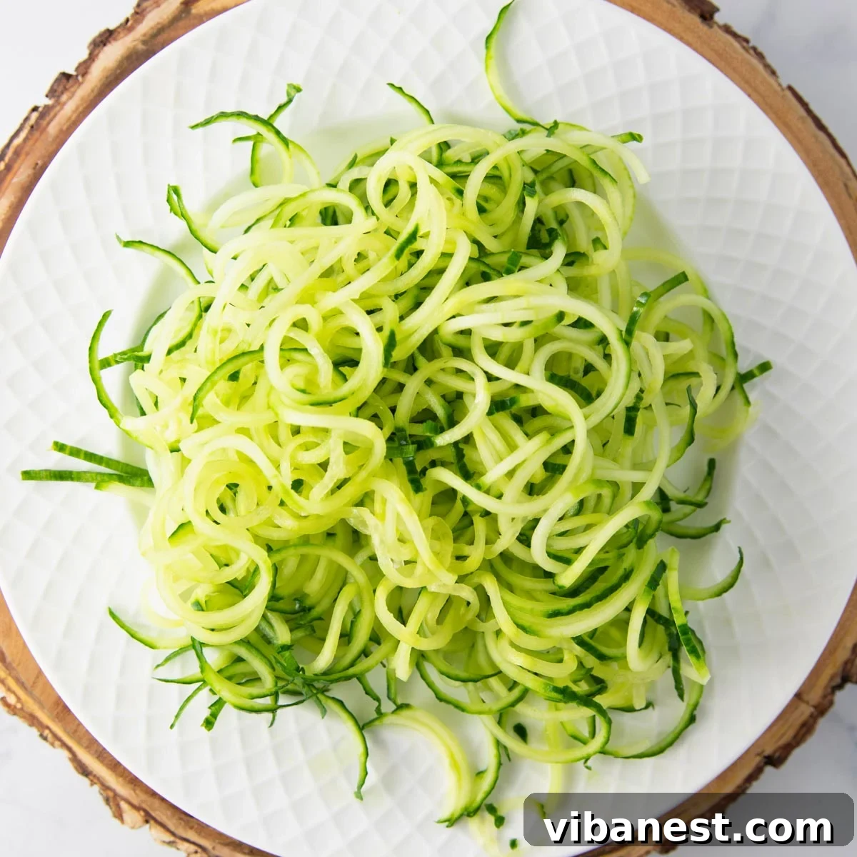 TikToks Viral Cucumber Salad Duet 3 Spiralized cucumbers resembling noodles, ready for dressing, showcasing an alternative preparation method for the viral salad.