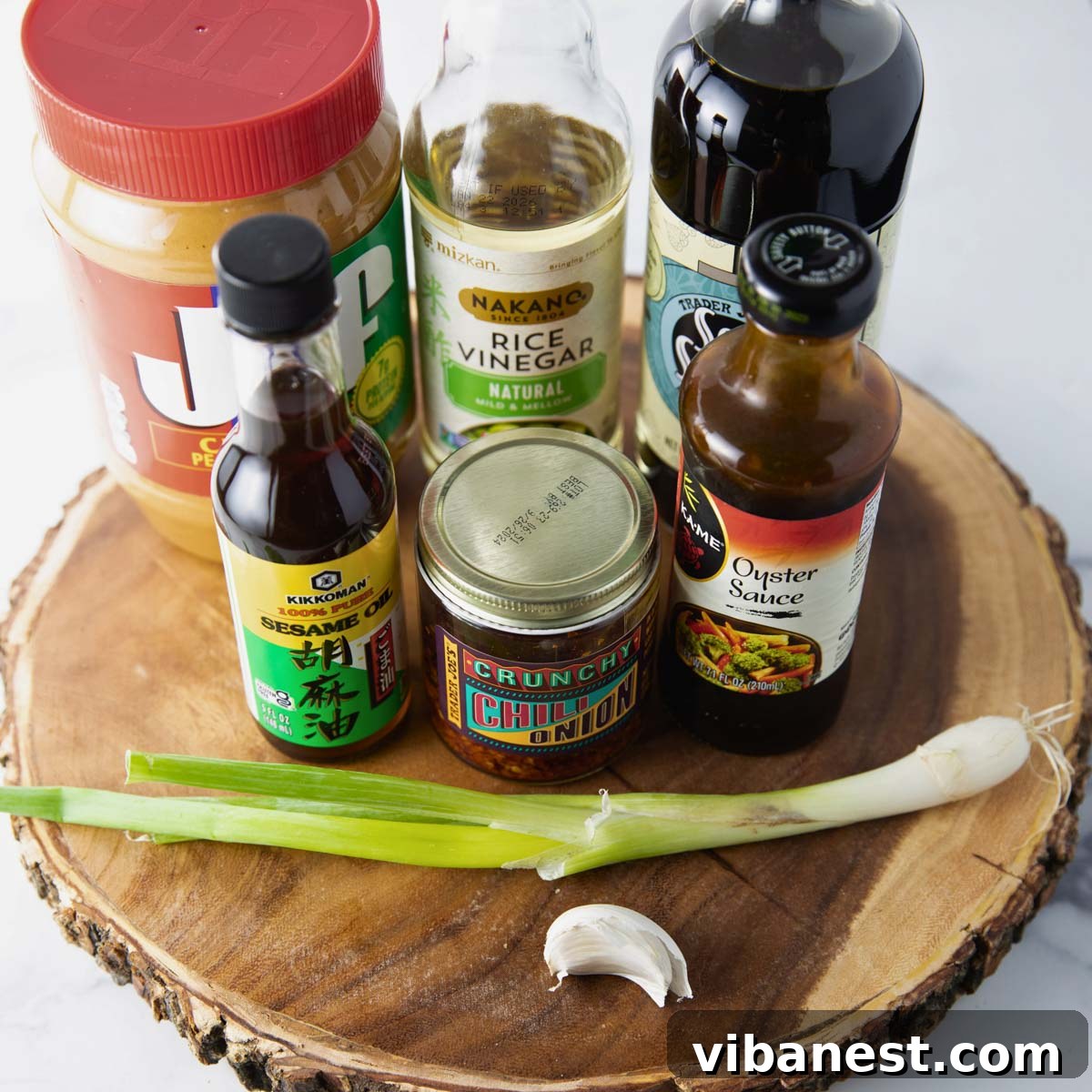 TikToks Viral Cucumber Salad Duet 5 A selection of fresh ingredients laid out for the Asian-inspired viral TikTok cucumber salad, including various sauces, spices, and a whole cucumber.