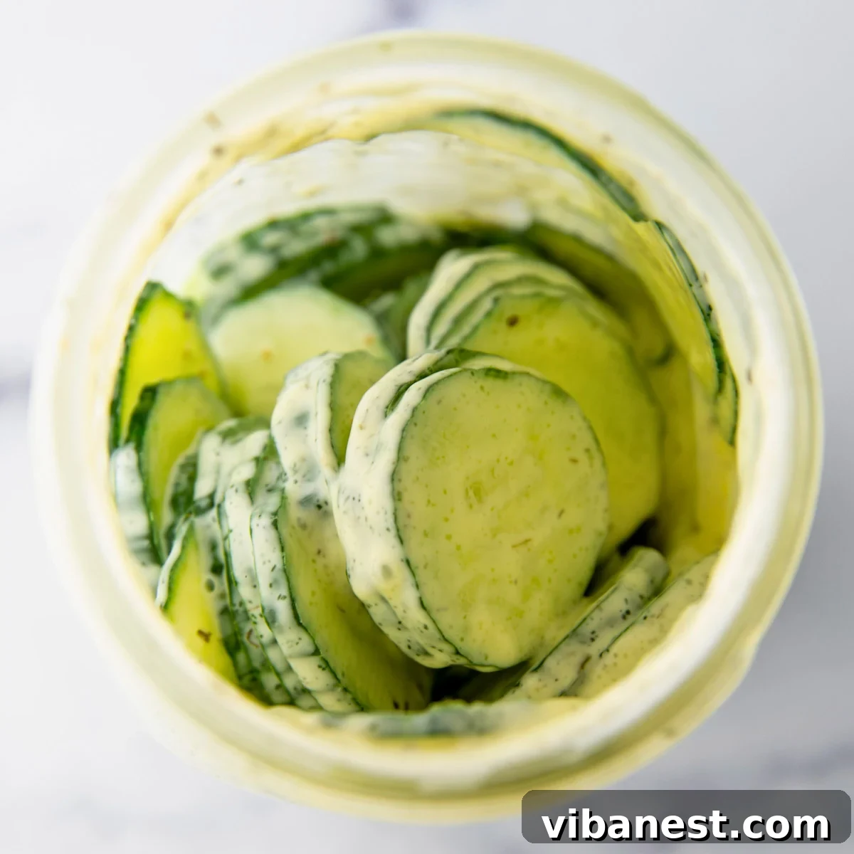 TikToks Viral Cucumber Salad Duet 8 A mason jar filled with cucumber slices and dressing, with a lid securely fastened, ready to be shaken.