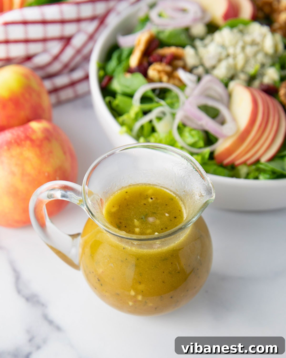 Crisp Apple Vinaigrette 6 A glass jar with the freshly mixed apple cider vinaigrette dressing, showcasing its vibrant color, ready to be served or stored.