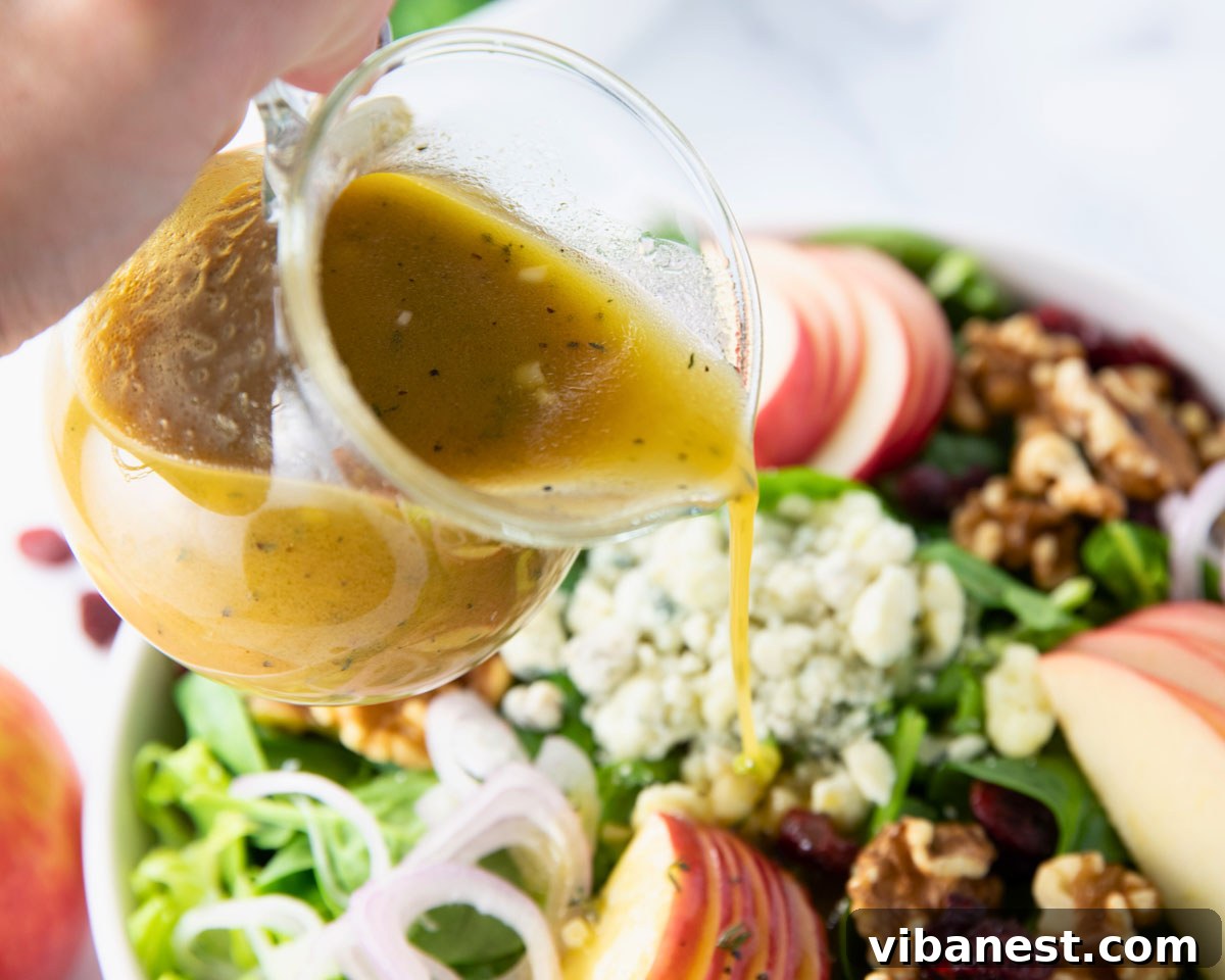 Autumn Abundance Bowl 5 A small bowl of homemade apple cider vinaigrette dressing, perfectly complementing the Fall Harvest Salad ingredients.
