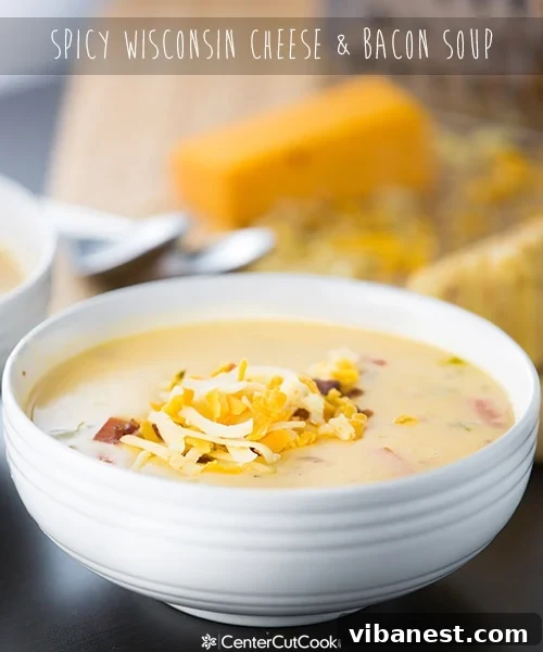 Various ingredients for Spicy Wisconsin Cheese & Bacon Soup laid out, including freshly shredded cheese