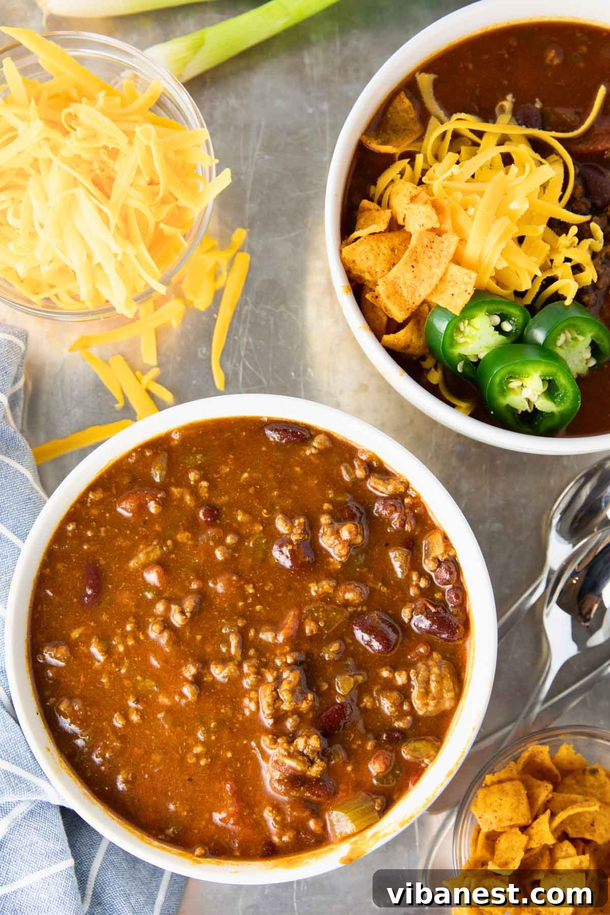 Ultimate Instant Pot Chili 6 A bowl of Instant Pot chili topped with cheese, onions, and sour cream