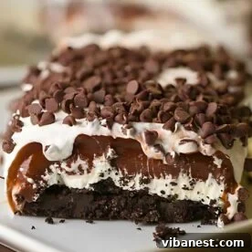 A slice of delectable Chocolate Lasagna, showcasing its irresistible layers of cookies, cream cheese, pudding, and whipped topping