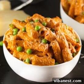 A serving of Spicy Chicken Rigatoni, featuring creamy and spicy sauce with chicken and peas