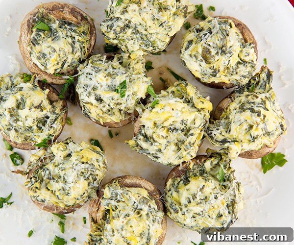 Spinach Artichoke Mushroom Poppers 6 Spinach artichoke stuffed mushrooms baking in a muffin tin