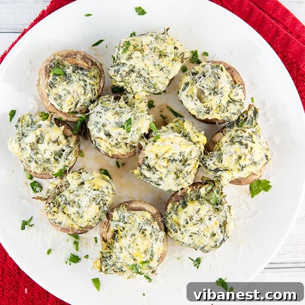 Spinach Artichoke Mushroom Poppers 7 Platter of freshly baked spinach artichoke stuffed mushrooms