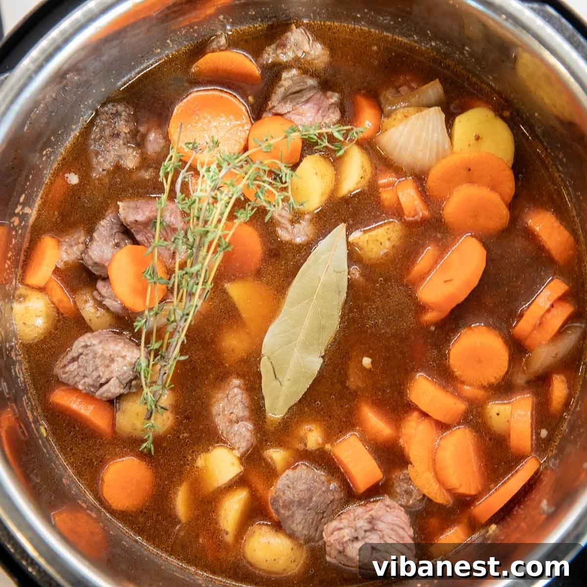 Instant Pot Irish Comfort Stew 12 Adding fresh thyme sprigs and a bay leaf to the stew for aromatic flavor.