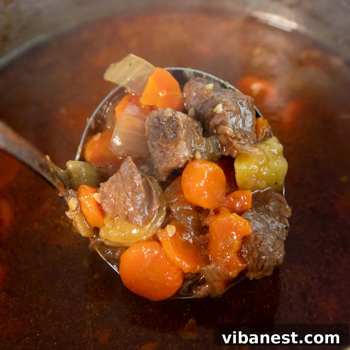 Instant Pot Irish Comfort Stew 14 Cooked beef stew after pressure release, showing tender meat, potatoes, and carrots in a rich broth.