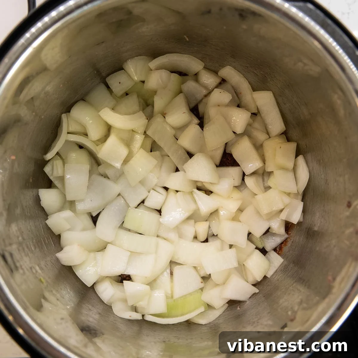 Instant Pot Irish Comfort Stew 8 Onions sautéing in the Instant Pot until soft and lightly golden.