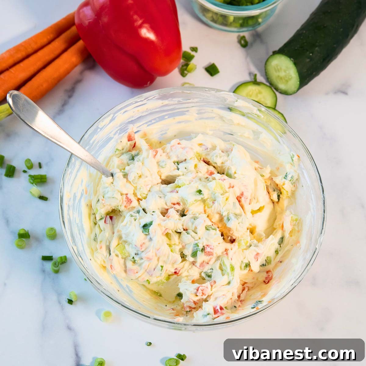 Garden Fresh Cream Cheese Veggie Spread 6 Finely chopped carrots, bell peppers, cucumbers, and green onions added to cream cheese.