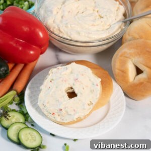 fresh homemade veggie cream cheese spread on a toasted bagel.