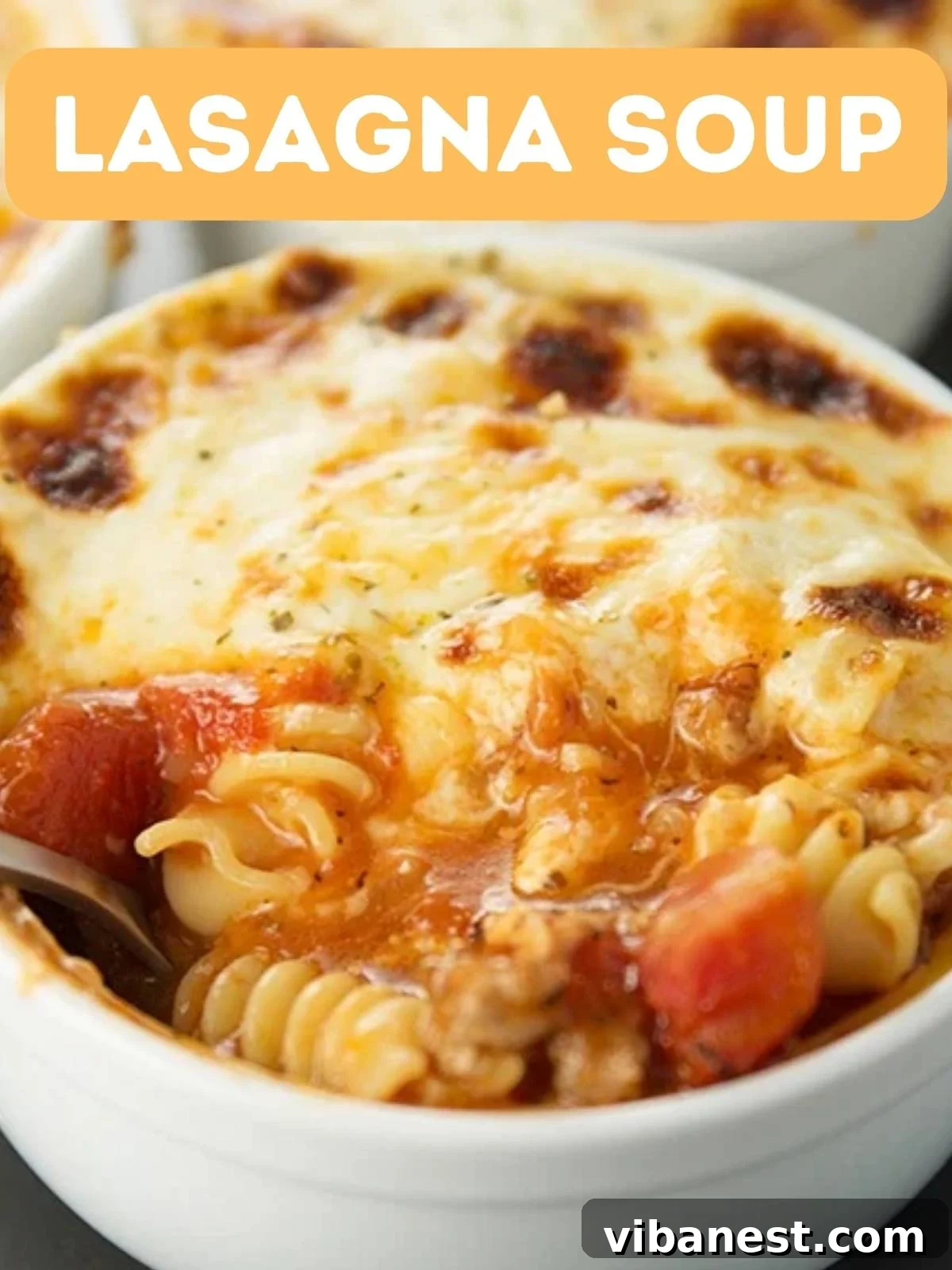 Hearty Lasagna Soup 2 A steaming bowl of homemade lasagna soup, garnished with fresh basil and a generous dollop of creamy cheese.