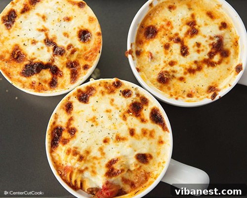 lasagna soup 3.jpg A perfectly broiled bowl of lasagna soup, with bubbling, golden-brown cheese and visible herbs.