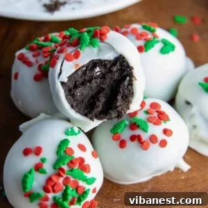 Perfectly round, chocolate-dipped Oreo truffles, ready to be enjoyed as a festive holiday treat.