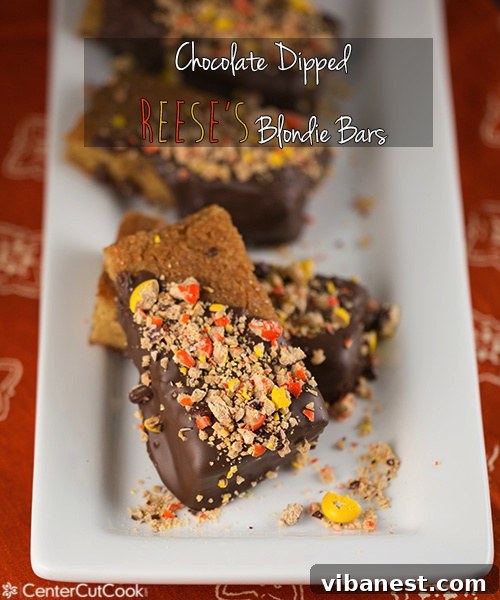 Chocolate Dipped Reese's Blondie Bars Stack Close-up of a stack of chocolate dipped Reese's blondie bars, showing the rich chocolate coating and colorful candies