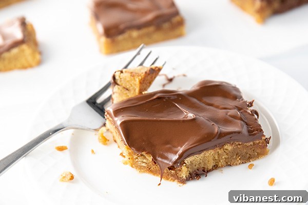 Blondie bars cooling on a wire rack with melted chocolate topping