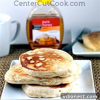 Close-up of a stack of fresh pan-fried scones with melted butter and honey