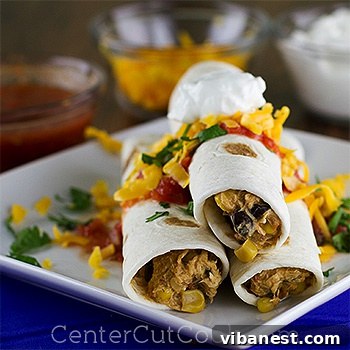 Cheesy Tex-Mex Chicken Ready A close-up of creamy shredded Tex-Mex chicken in a slow cooker, garnished and ready to serve