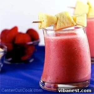Tropical Berry Bliss 4 A vibrant strawberry pineapple smoothie in a glass, ready to be served.