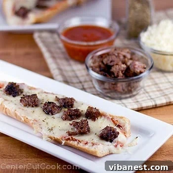 Homemade French Bread Pizza Close-up of freshly baked French bread pizza with melted cheese and Italian sausage