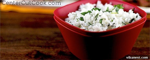 Freshly prepared Cilantro Lime Rice, vibrant green with herbs, in a serving bowl