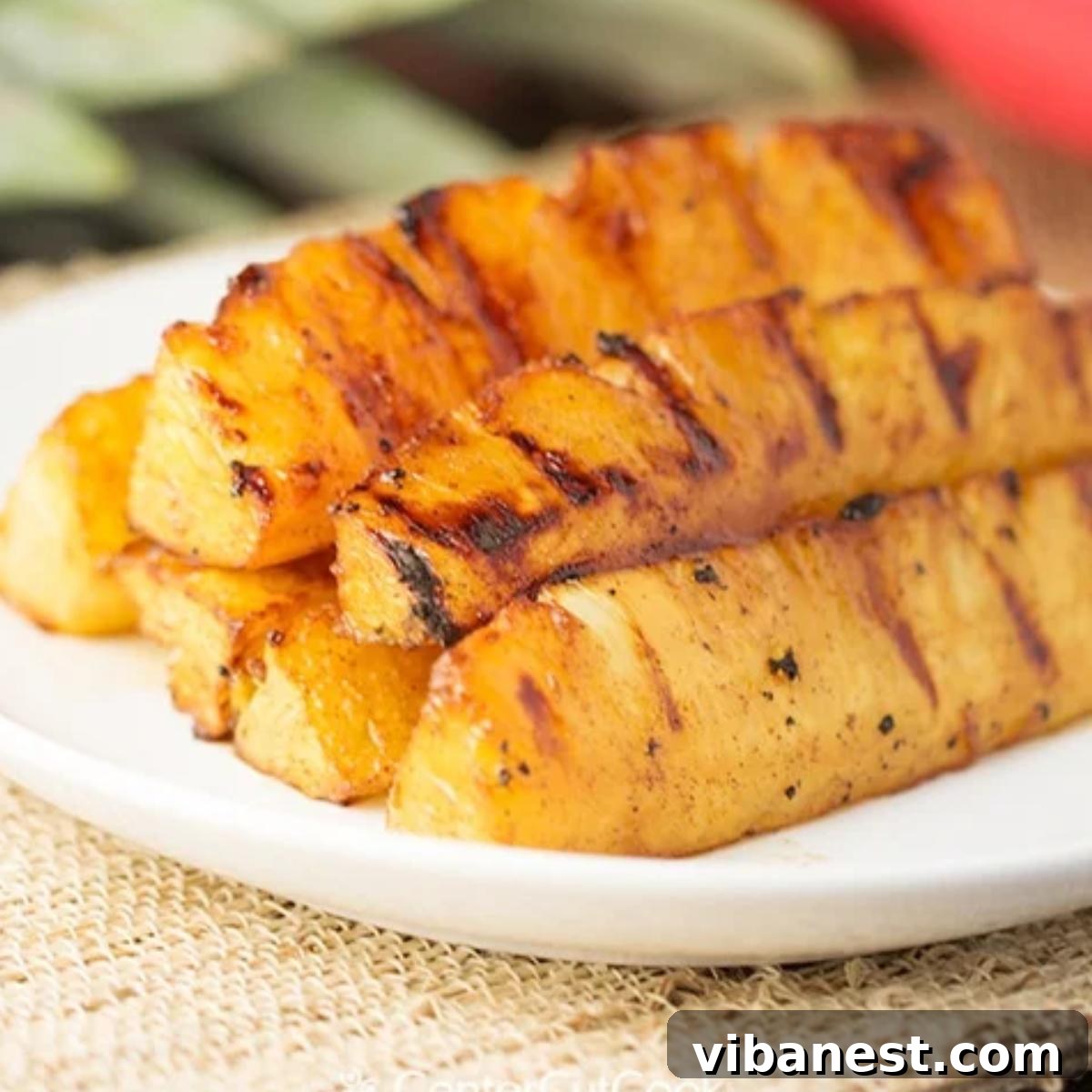 Caramelized Grilled Pineapple 2 Grilled pineapple spears coated in brown sugar and cinnamon, ready for the grill