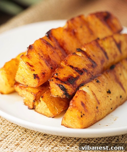 grilled pineapple 5.jpg Fresh pineapple being prepared for grilling, showing a hint of the brown sugar and cinnamon coating
