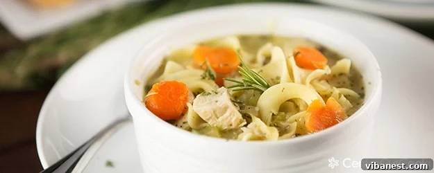 Warm and Inviting Chicken Noodle Soup Close-up of a rustic bowl of chicken noodle soup with steam rising, on a wooden surface.
