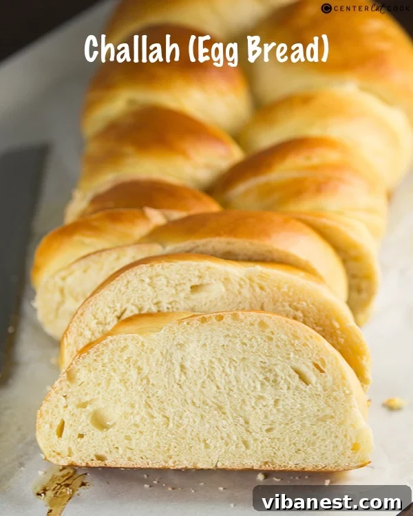A beautifully braided Challah loaf on a wooden surface