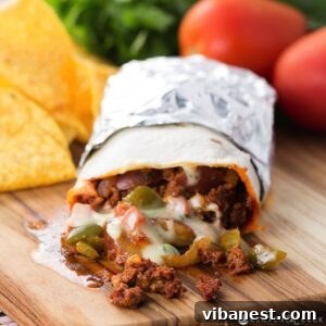 Ultimate Chorizo Potato and Queso Burritos 2 A perfectly rolled Chorizo, Potato, and Queso Burrito, cut in half to reveal its delicious filling.