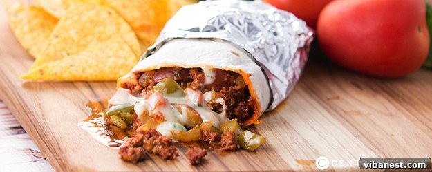 Chorizo Potato Queso Burrito Halves Two halves of a Chorizo, Potato, and Queso Burrito, showing the hearty filling and creamy queso oozing out.