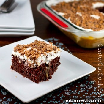 Easy Decadent Better Than Sex Cake Decadent Better Than Sex Cake, a rich chocolate dessert topped with fluffy whipped cream and chocolate shavings, served in a glass baking dish.