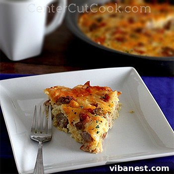 Easy Amish Breakfast Casserole Golden brown Amish Breakfast Casserole, freshly baked and steaming, showing hearty eggs, sausage, and cheese, ready to be served.