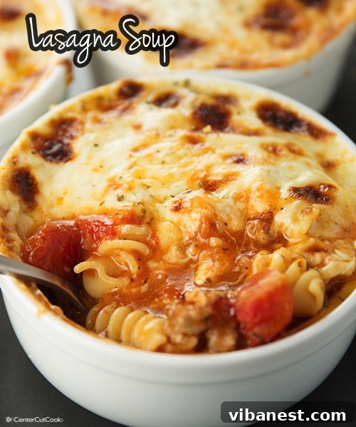 Comforting Lasagna Soup Recipe A bowl of hearty Lasagna Soup topped generously with creamy ricotta cheese, fresh basil, and shredded mozzarella, served with crusty bread.