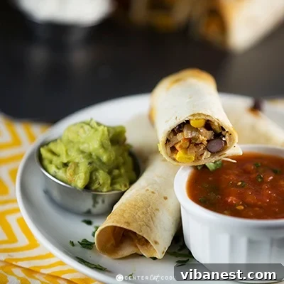 chicken flautas 2.jpg A delicious single baked chicken flauta ready to be dipped, showcasing its crispy texture and the creamy filling.