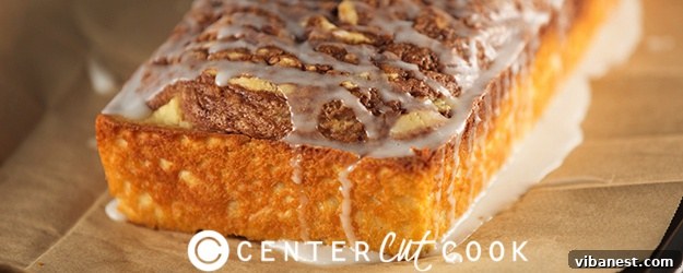 Whole Cinnamon Roll Bread Loaf Cinnamon Roll Bread loaf on a wooden cutting board, ready to be sliced