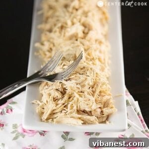 plate of easy slow cooker shredded chicken with two forks