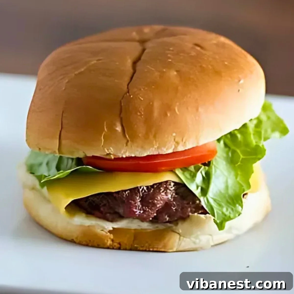 Grill Perfect Burgers Every Time 2 A comprehensive guide to grilling juicy burgers, showing a perfectly cooked burger with fresh toppings.