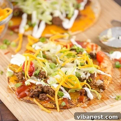 Taco Flatbread Pizza Recipe Showcase A finished Taco Flatbread Pizza, perfectly sliced into wedges and garnished with fresh toppings