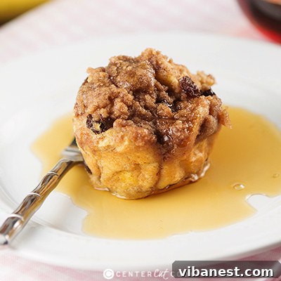 Maple Syrup Drizzled French Toast Muffins Several French Toast Muffins stacked on a plate, drizzled with maple syrup
