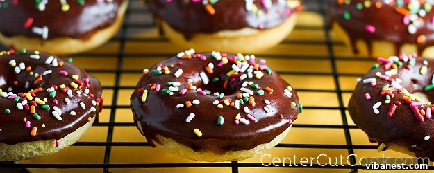 Delicious baked donuts with a rich chocolate glaze and colorful sprinkles