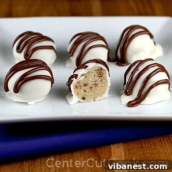 Finished Chocolate Peanut Butter Cookie Dough Truffles Stack of finished cookie dough truffles with chocolate drizzle