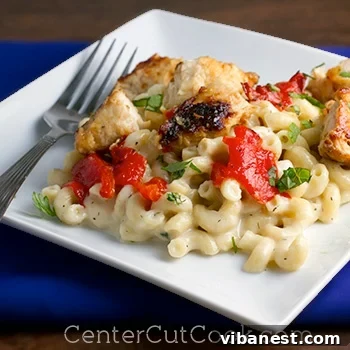 Delicious Herbed Havarti Mac and Cheese Close-up of Herbed Havarti Macaroni and Cheese with chicken and red peppers, showing creamy texture.
